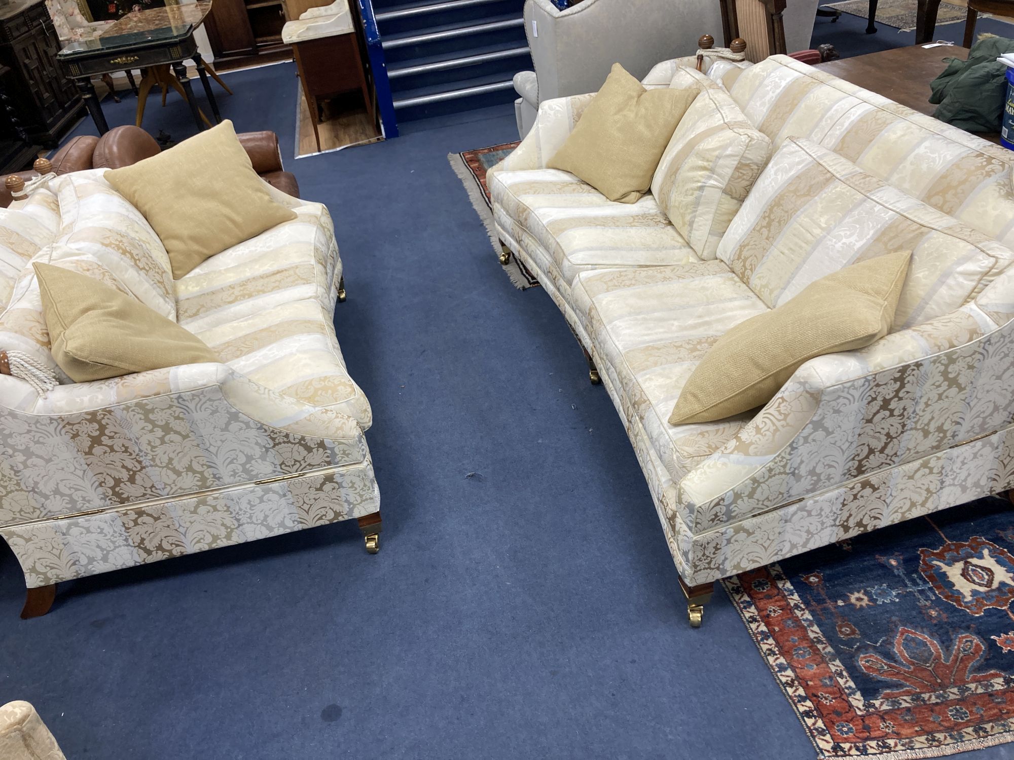 Harrods. Two large two seater settees, upholstered in cream brocade, larger 238cm, depth 118cm, height 85cm